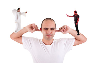 Image showing man holding fingers in his ears, not listening, discussion between the devil and angel