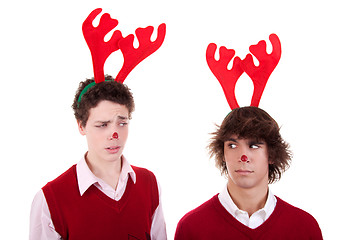 Image showing happy young men wearing reindeer horns, admired, on white, studio shot
