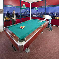 Image showing Two people playing pool