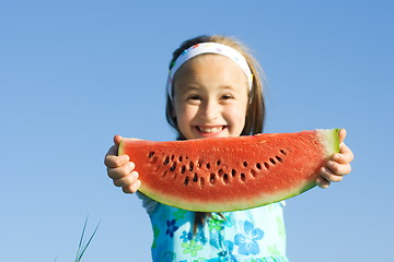 Image showing Girl showing a watermelon slice