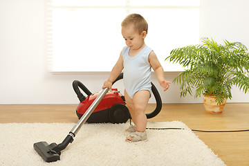 Image showing Baby boy with vacuum cleaner