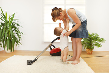 Image showing Mother cleaning the floor