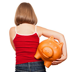 Image showing Girl walking away with piggy bank