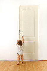 Image showing Baby in front of door