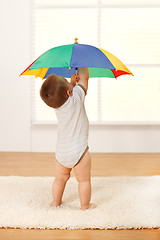 Image showing Baby boy opening the umbrella