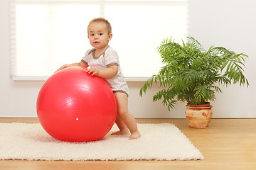 Image showing Baby boy with big red ball