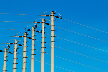 Image showing High-voltage pole against a blue sky 