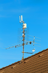 Image showing television antenna and wi-fi transmitter on the roof