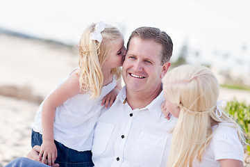 Image showing Handsome Dad Getting Kisses from His Cute Daughters 