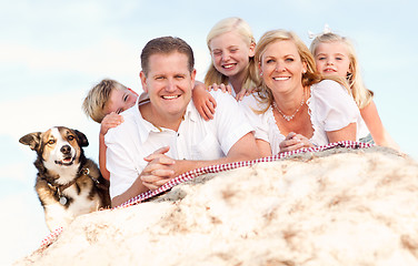 Image showing Happy Caucasian Family and Dog Portrait at the Beach