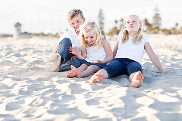 Image showing Adorable Sisters and Brother Having Fun at the Beach