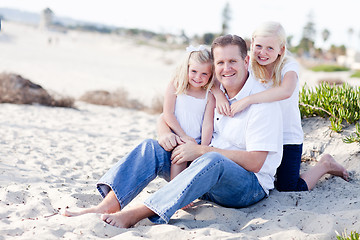 Image showing Handsome Dad and His Cute Daughters at The Beach