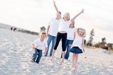 Image showing Happy Sibling Children Jumping for Joy