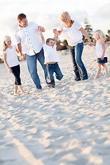 Image showing Happy Young Boy Swinging with His Parents