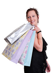 Image showing young woman with shopping bags on white