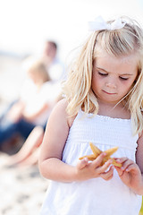 Image showing Adorable Little Blonde Girl with Starfish