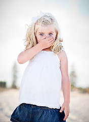 Image showing Adorable Blue Eyed Girl Covering Her Mouth