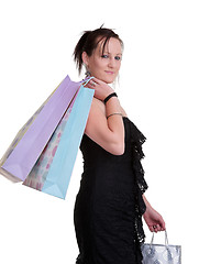 Image showing young woman with shopping bags on white