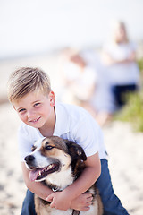 Image showing Handsome Young Boy Playing with His Dog