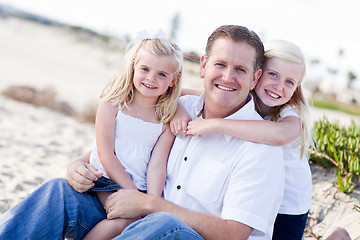 Image showing Handsome Dad and His Cute Daughters at The Beach