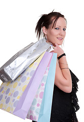 Image showing young woman with shopping bags on white