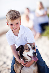 Image showing Handsome Young Boy Playing with His Dog