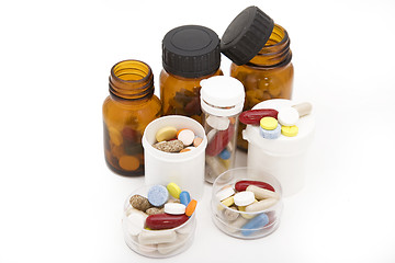 Image showing colored stream of pills and pill bottles