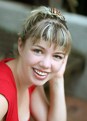 Image showing Smiling blond girl in red