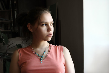 Image showing Unhappy teen by the window