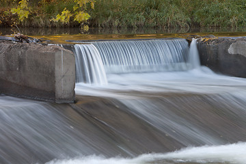 Image showing old river dam with falling water