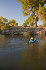Image showing kayaker paddling across a river