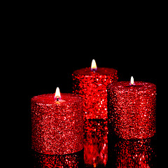 Image showing Three spangled candles in the dark