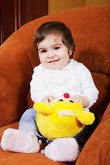 Image showing Smiling baby girl with toy