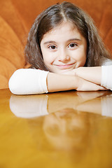 Image showing Little brunette with long hair at table