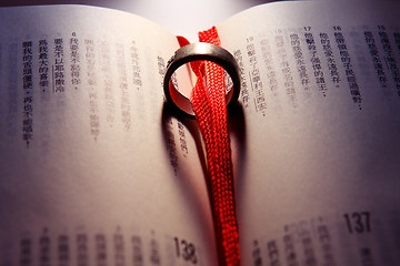 Image showing Wedding Ring on a chinese bible