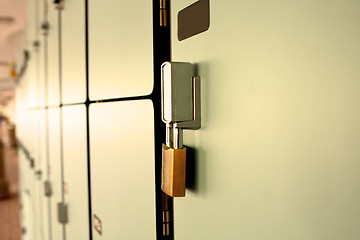 Image showing Closeup view of a lock on a school locker with row of lockers 