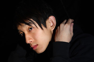 Image showing asian man over dark background