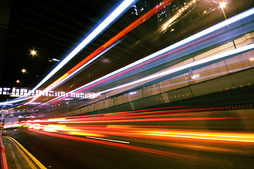 Image showing light trails on the modern building background