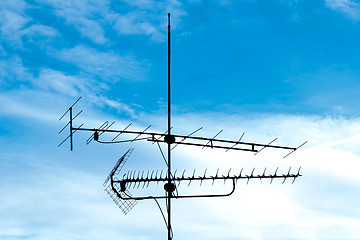 Image showing old analog television antenna against blue sky