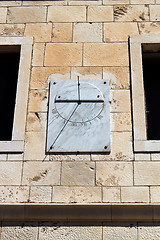 Image showing marble sun-dial between two windows