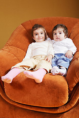 Image showing Sisters sitting in chair