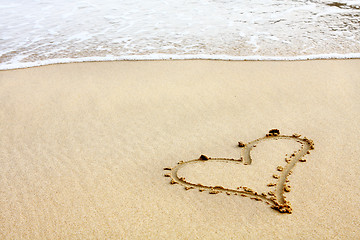 Image showing hearts drawn in the sand with seafoam and wave