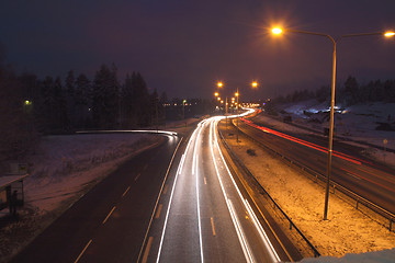 Image showing In winter car lights in the night on the town road.
