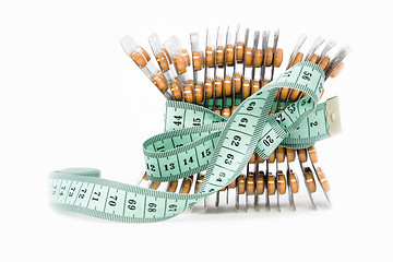 Image showing measurement tape and orange pills