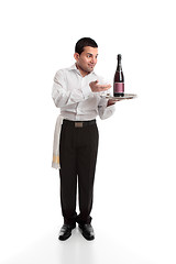 Image showing Waiter presenting a bottle of alcohol