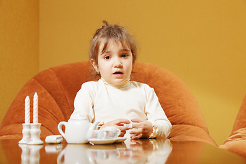 Image showing Little girl with toy dishware
