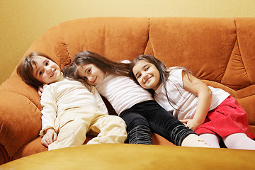 Image showing Three girls on sofa