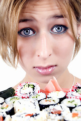 Image showing  young girl  with sushi