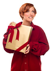 Image showing Pretty Red Haired Girl Biting Lip Holding Wrapped Gift