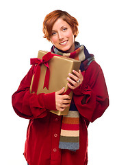 Image showing Pretty Red Haired Girl with Scarf Holding Wrapped Gift